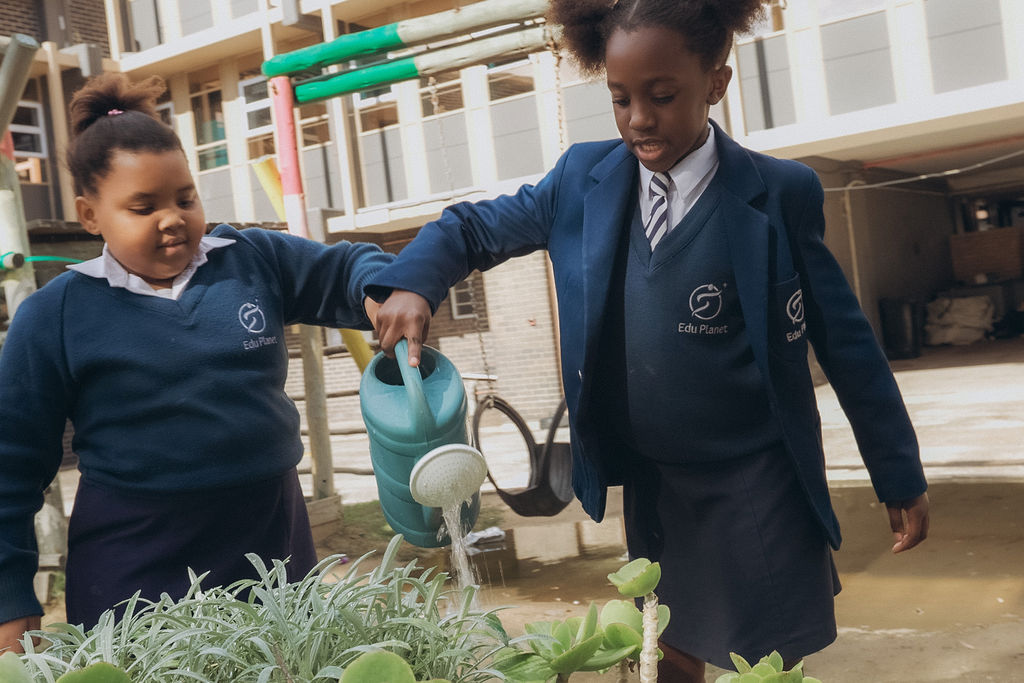 Learners watering plants together